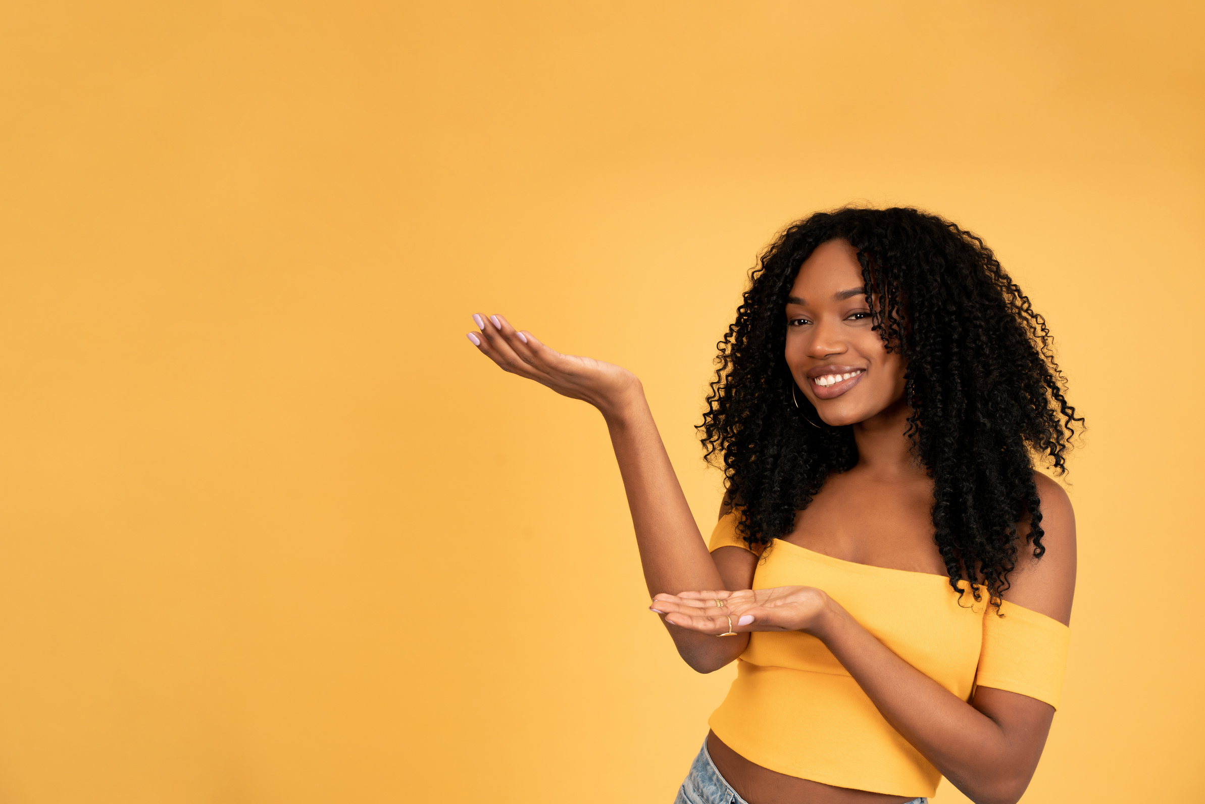 Young Afro Woman Showing Something with Her Hands.